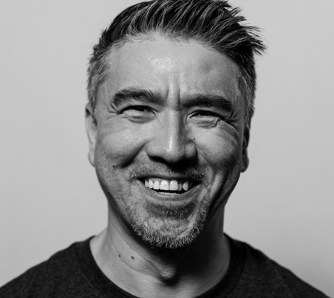 Black-and-white portrait of SpaceDharma founder Gabriel Ng smiling.